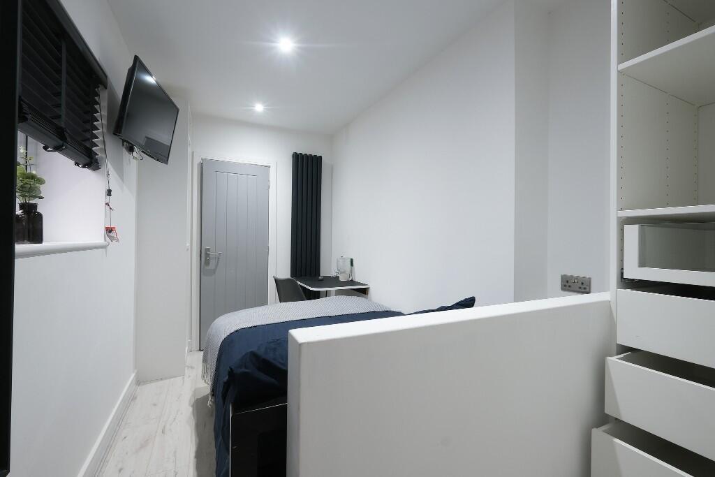 A bright and neatly maintained bedroom featurin...