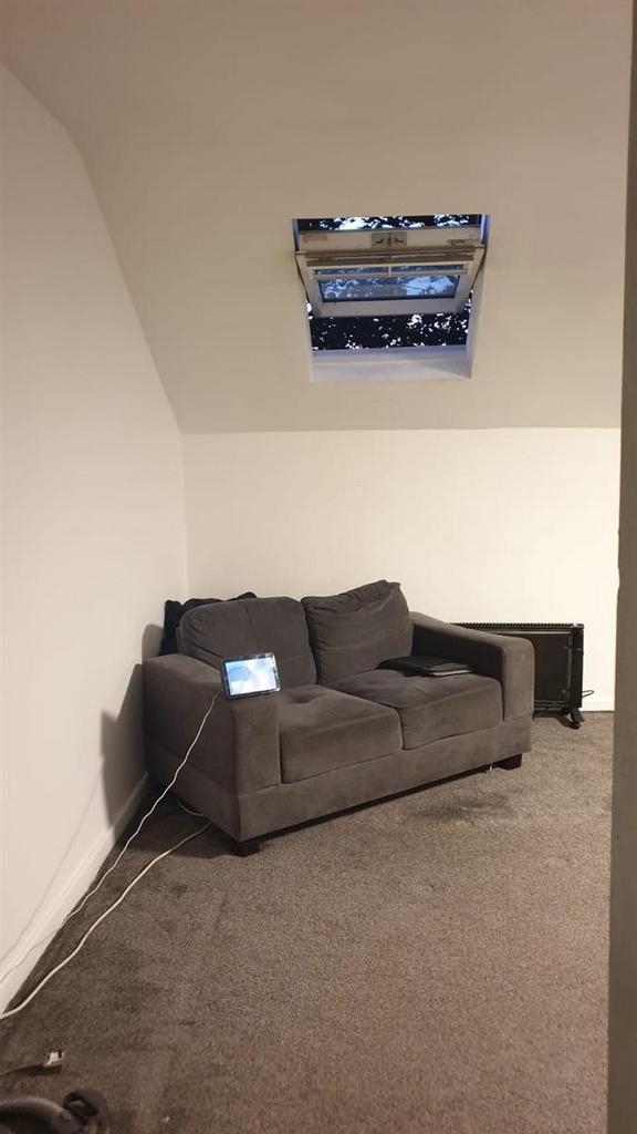 Cozy lounge area with a comfortable two-seater ...