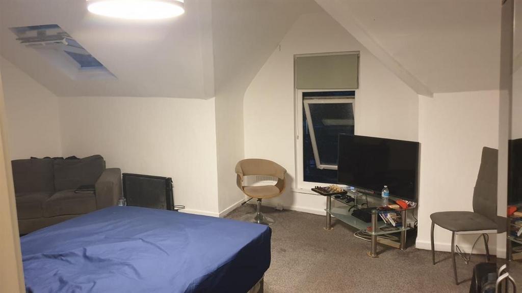 Spacious top-floor double bedroom with sloped c...