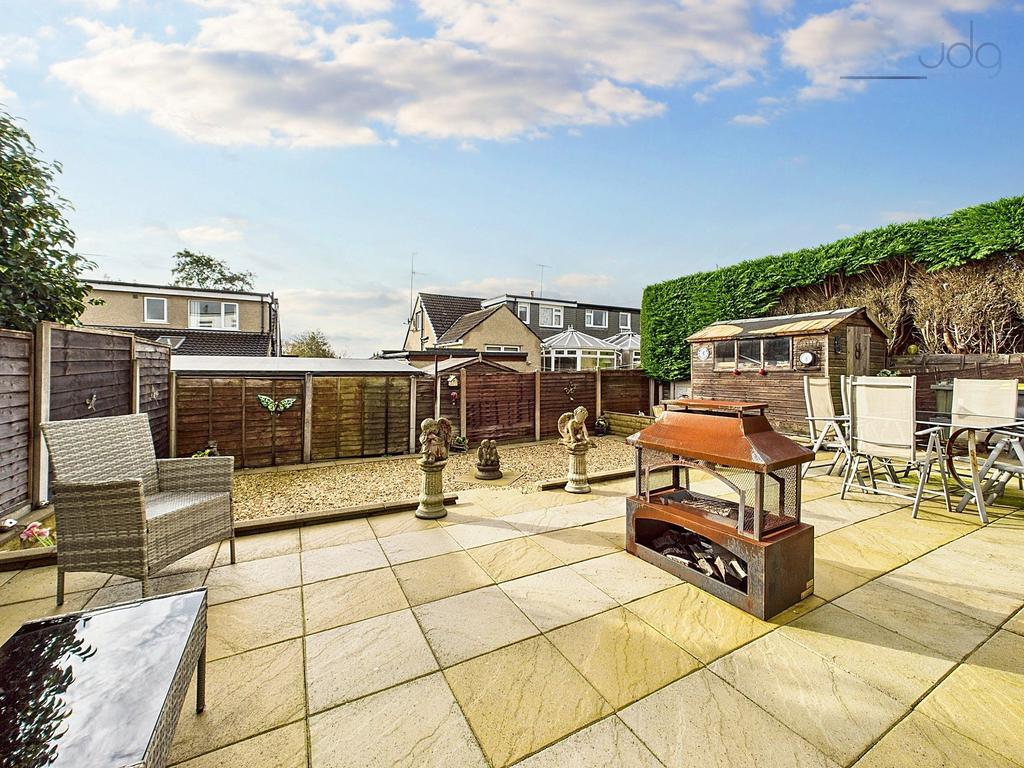 Garden featuring patio, gravel section, shed,...