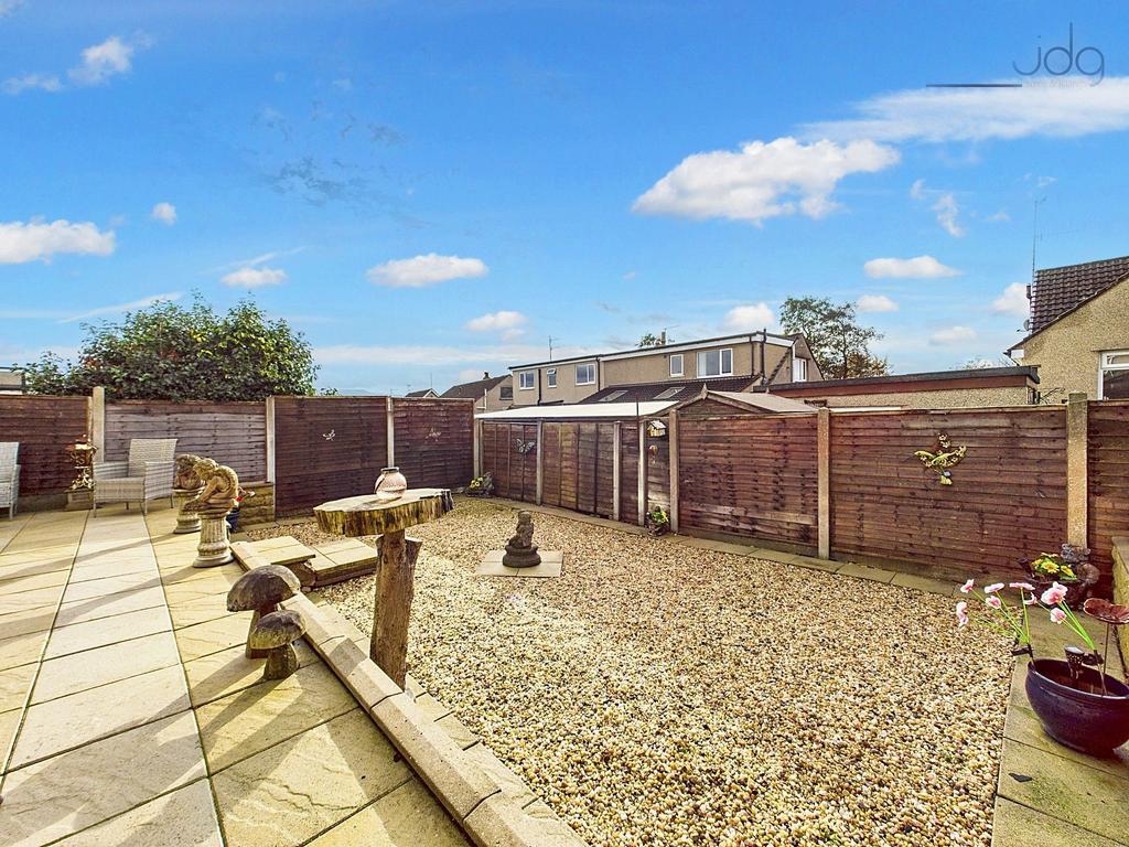 Garden featuring patio, gravel section, shed,...