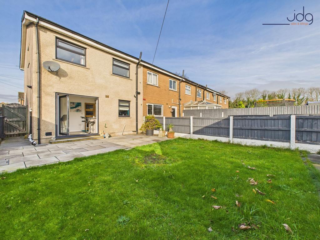 Generous garden combining lawn and paved areas,...