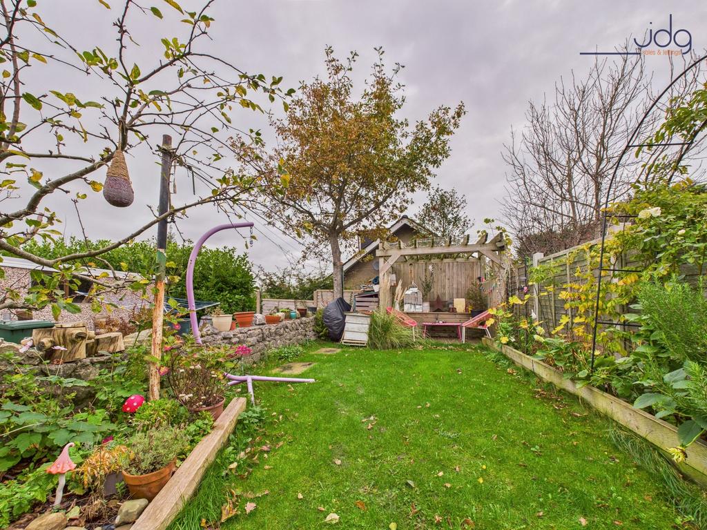 A ginnel separates the yard from the property’s...