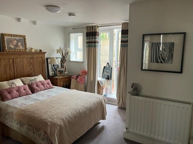 Bright, well-presented master bedroom with a la...