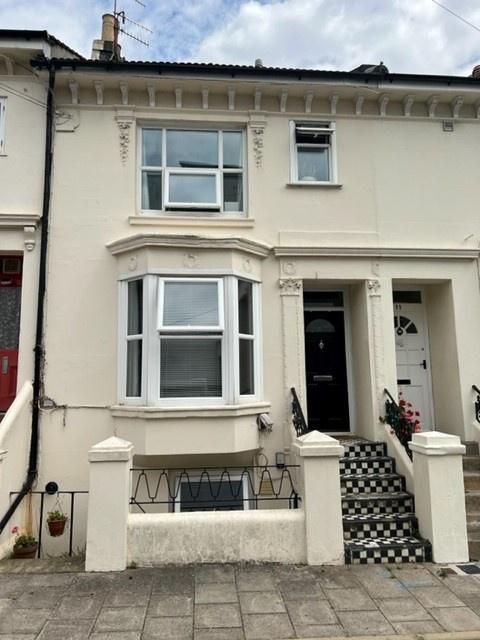 Attractive mid-terrace cream-painted townhouse ...