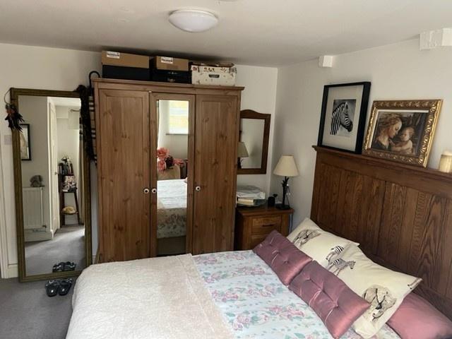 Warm, well-furnished double bedroom featuring a...
