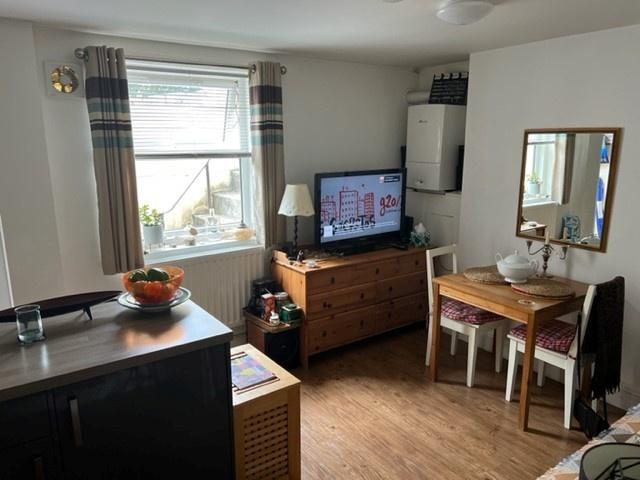 Bright open-plan kitchen area with a large wind...