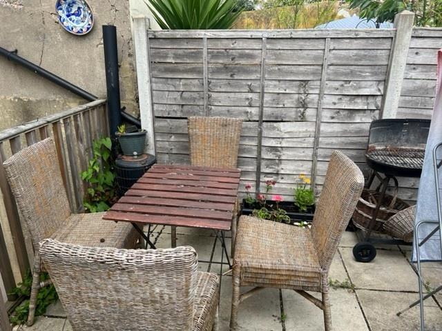 Private paved patio with a compact outdoor dini...