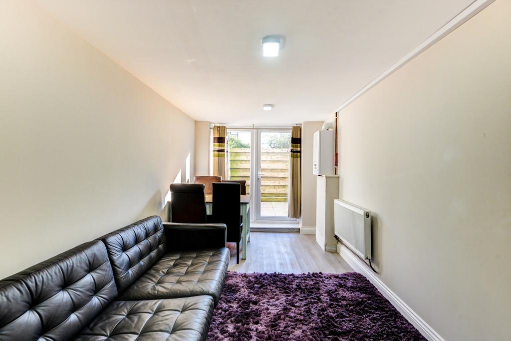 Bright, long living room with contemporary blac...