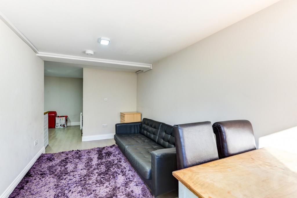 Bright, simply furnished living area with a com...