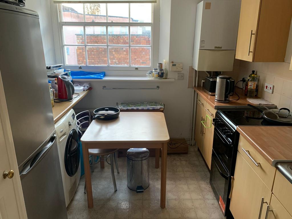 Compact, well-equipped kitchen with natural win...