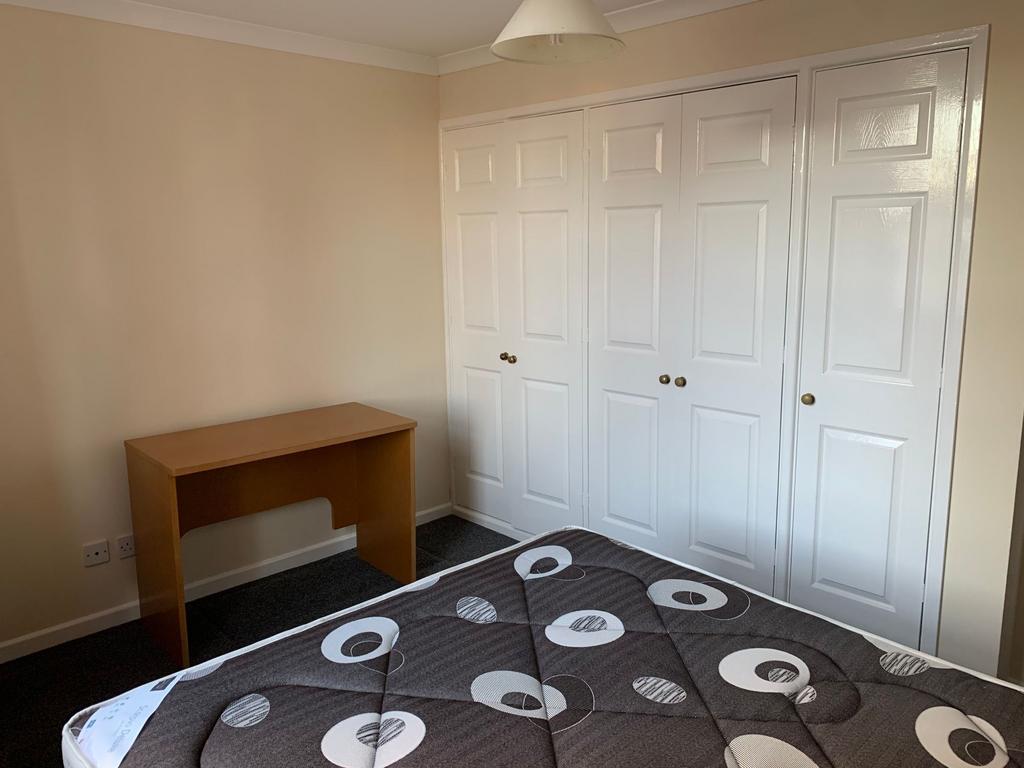 Bright, neatly presented bedroom with built-in ...