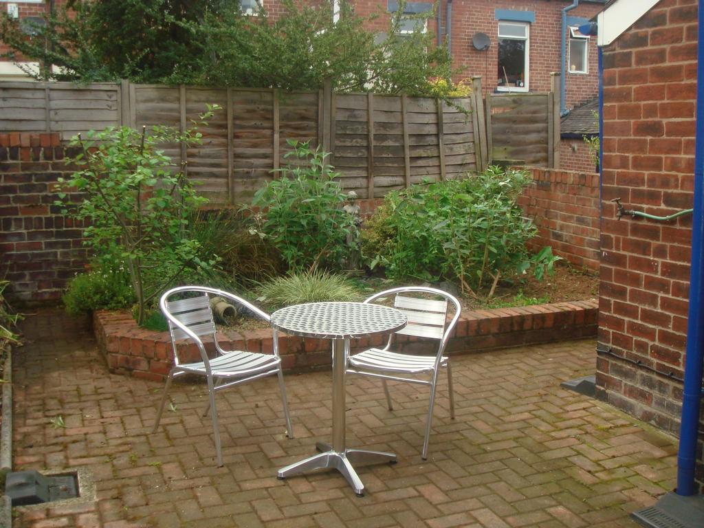 Private paved garden with a raised planted bord...