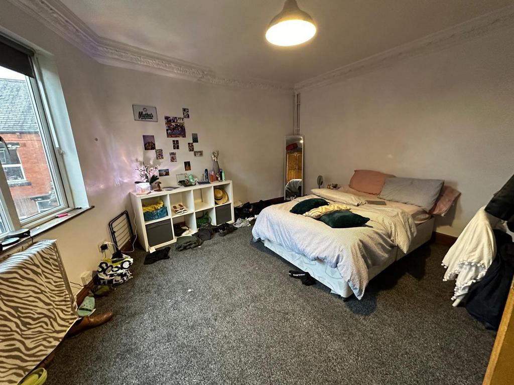 A cozy bedroom with a comfortable double bed, n...