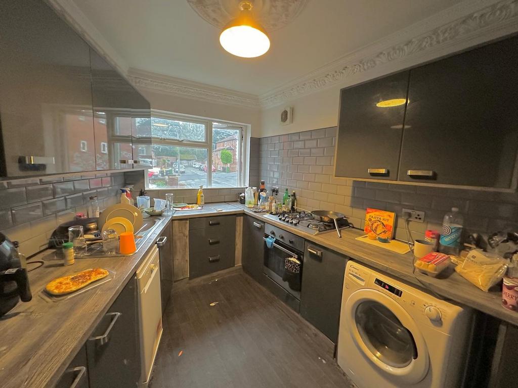 A well-equipped kitchen featuring modern cabine...