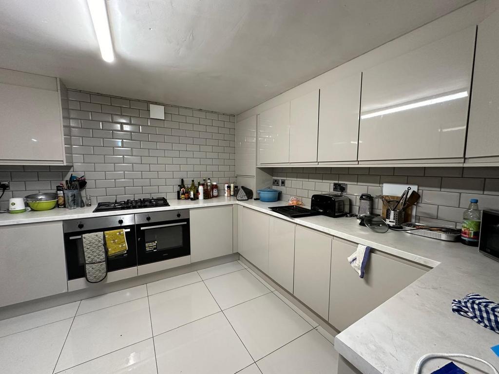 Bright and modern kitchen with ample white cabi...