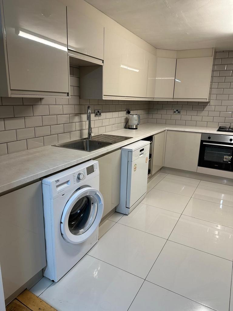 A modern and well-maintained kitchen with white...