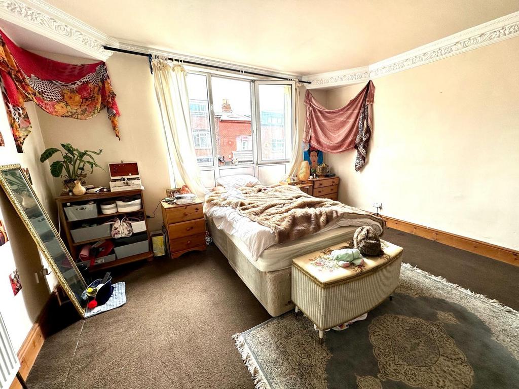 Spacious master bedroom with large windows prov...