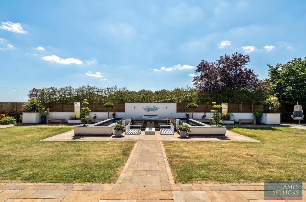 Sunken seating terrace with raised Koi Carp ponds