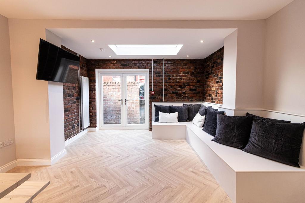 Modern living room with a stylish exposed brick...