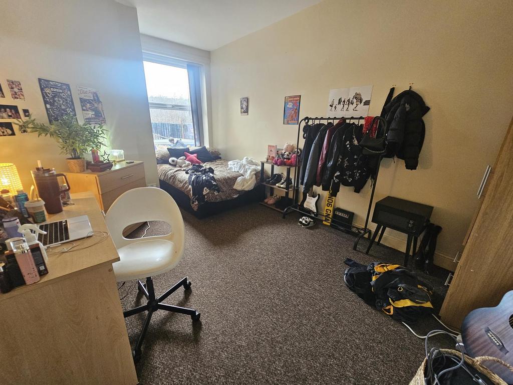 Cosy furnished bedroom with a comfy bed beneath...
