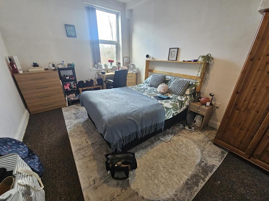 Bright, neatly presented bedroom with a comfort...