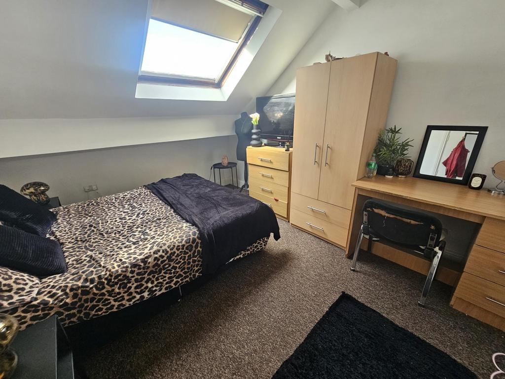 Bright attic double bedroom with a skylight, co...