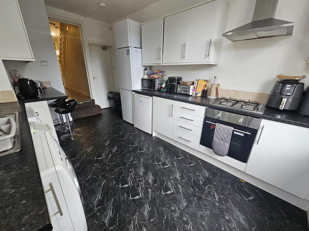 Bright modern kitchen with sleek white cabinetr...