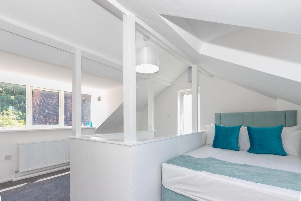 Bright, modern attic double bedroom with pitche...