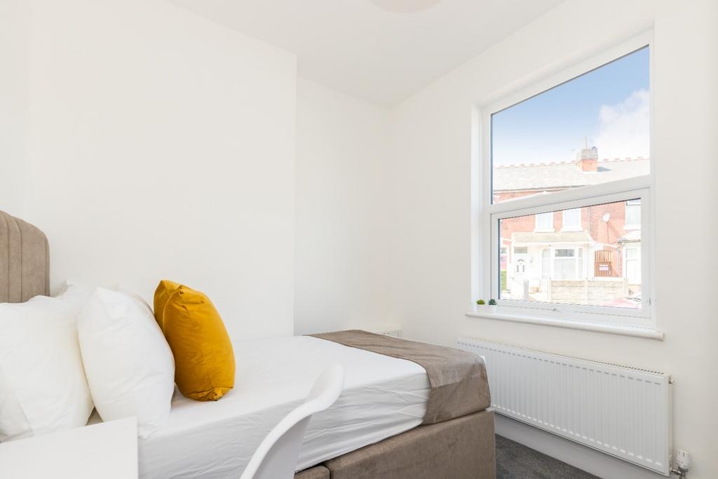 Bright, neatly presented bedroom with a comfort...