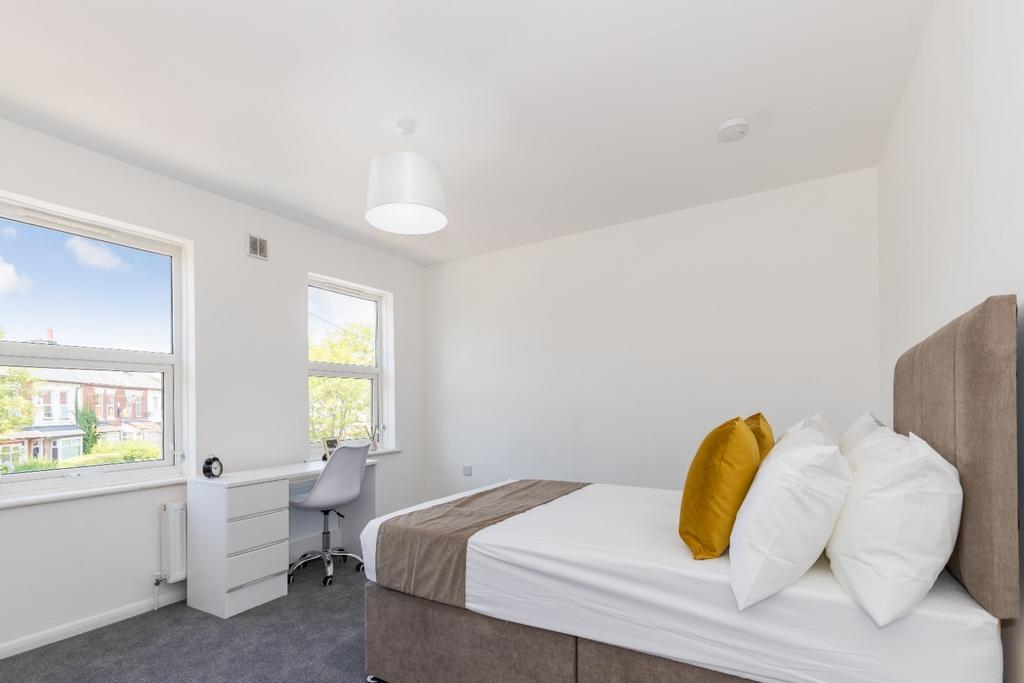 Bright, neatly presented bedroom with a comfort...