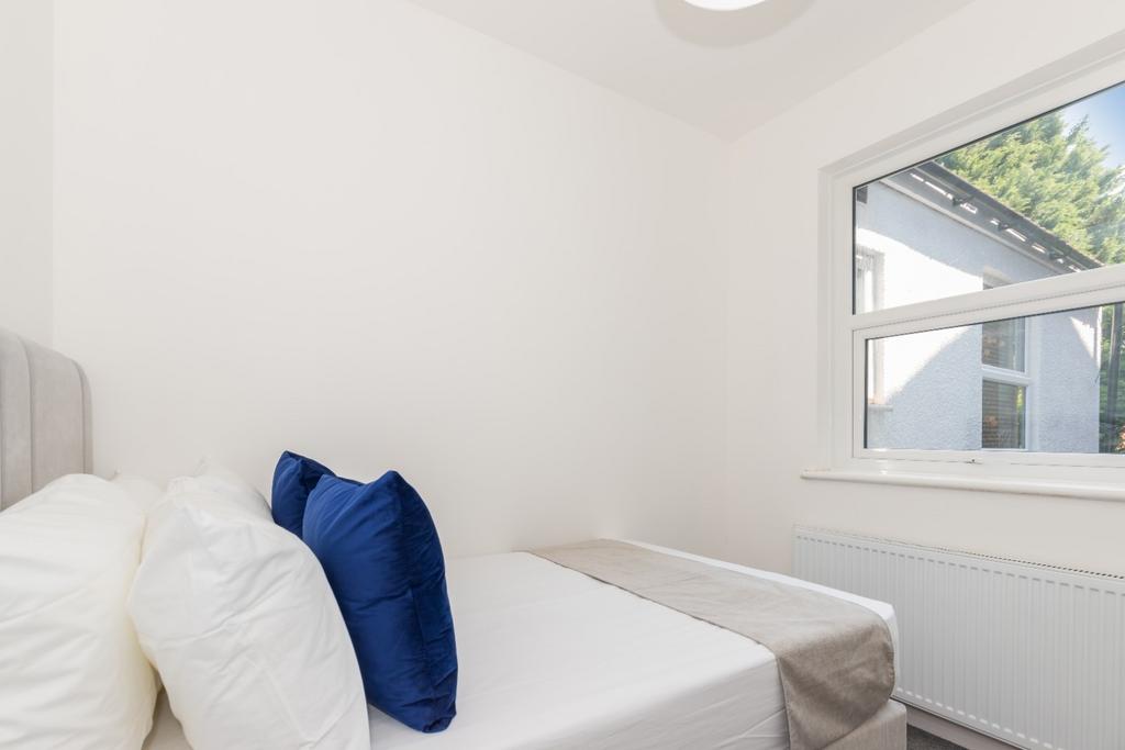 Neat, simply furnished bedroom with a comfy bed...