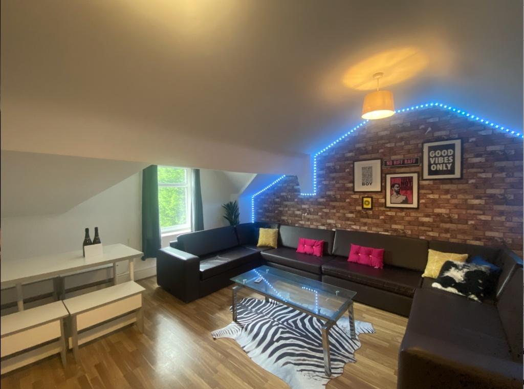 Contemporary attic-style living room with expos...