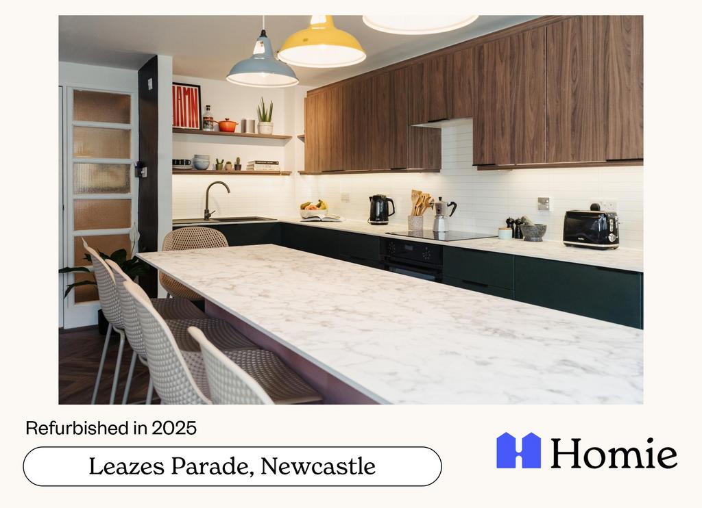 Modern fitted kitchen with a long marble-effect...