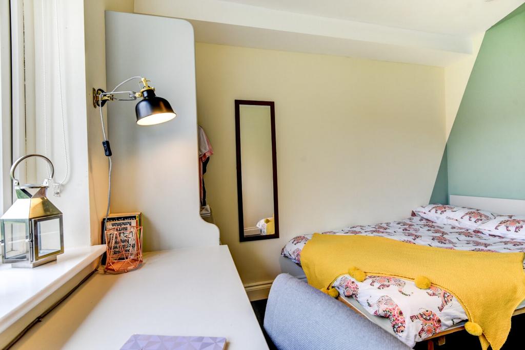 Bright and cozy master bedroom featuring a comf...