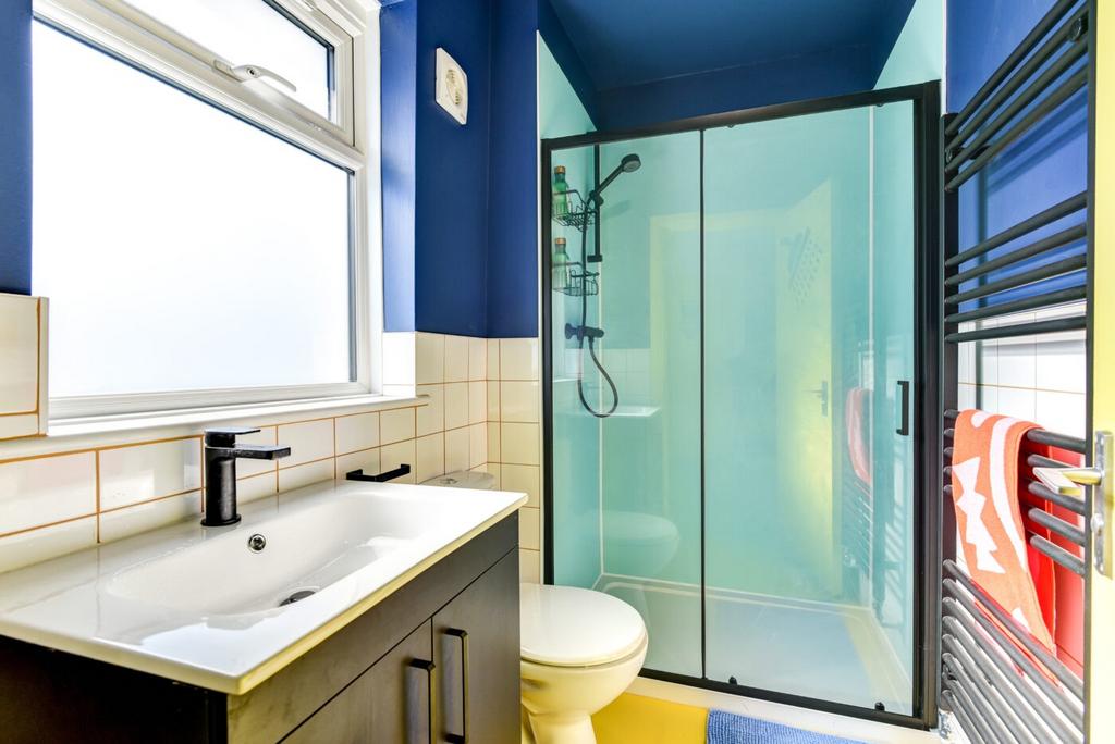 Bright and modern bathroom featuring a frosted ...