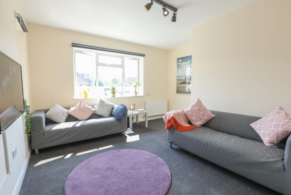 Bright and welcoming living room with ample nat...