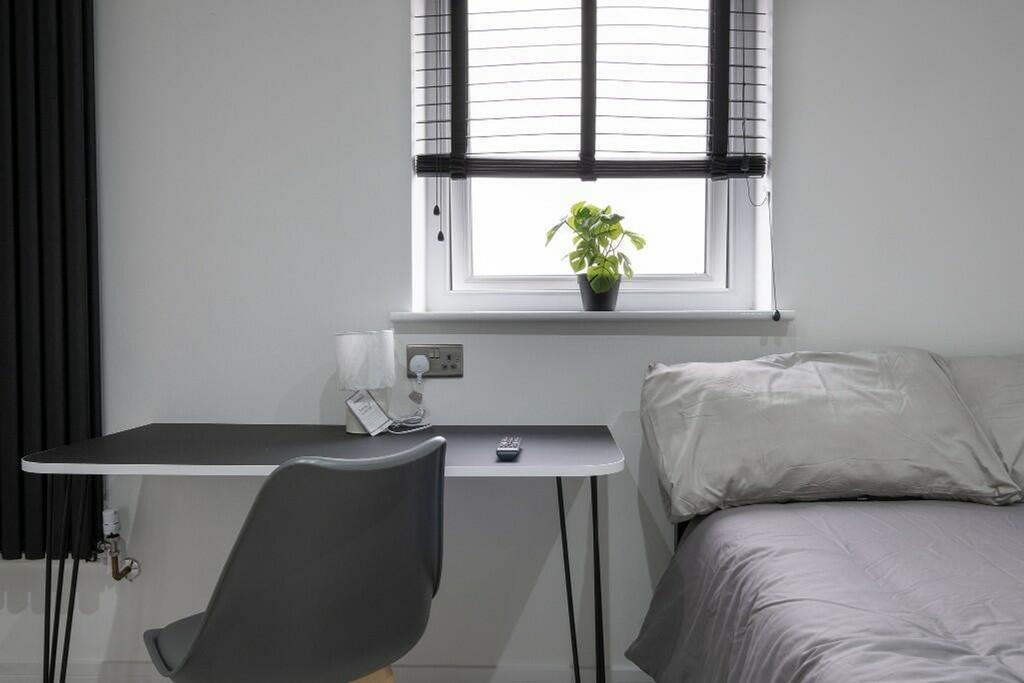 A stylish double bedroom featuring a comfortabl...