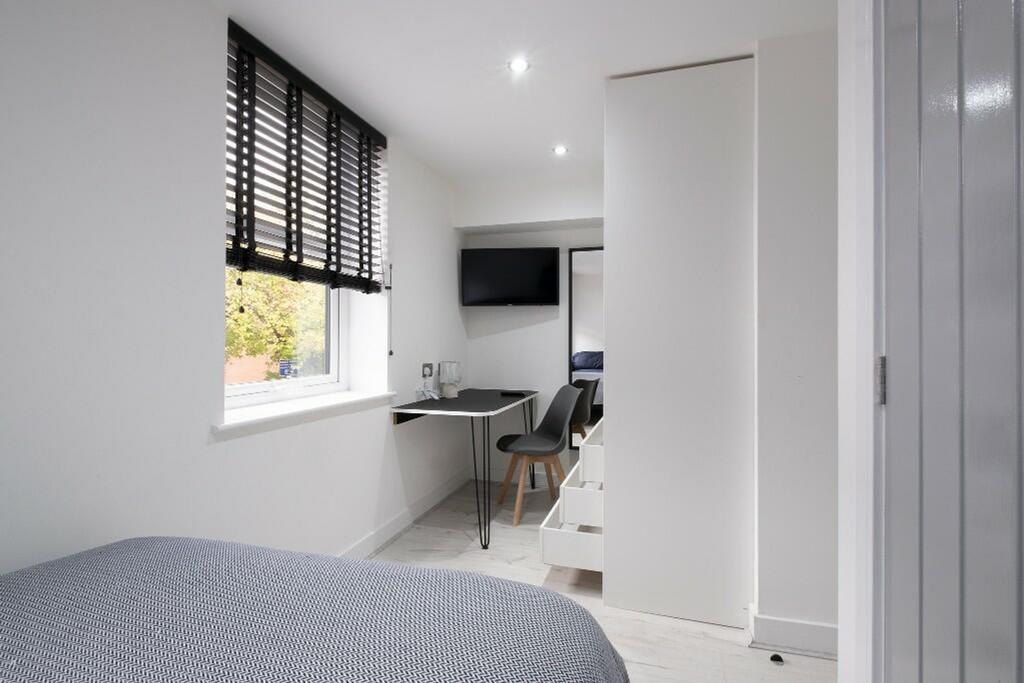This inviting double bedroom features a comfort...