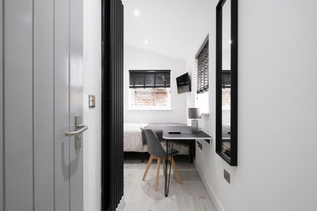 This inviting double bedroom features a cozy la...