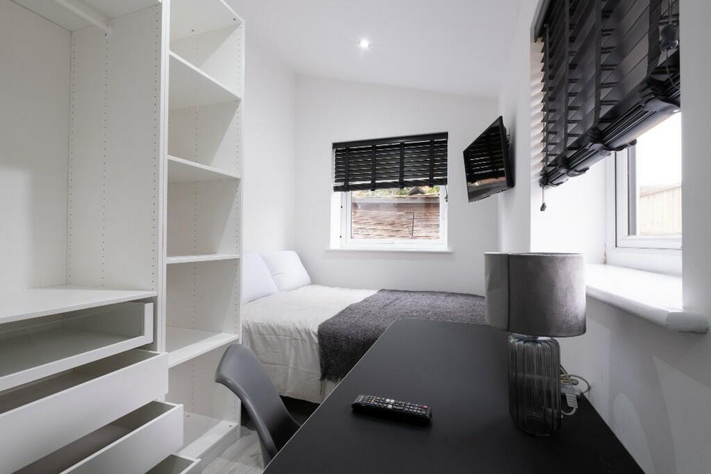 This stylish double bedroom features a cozy lay...