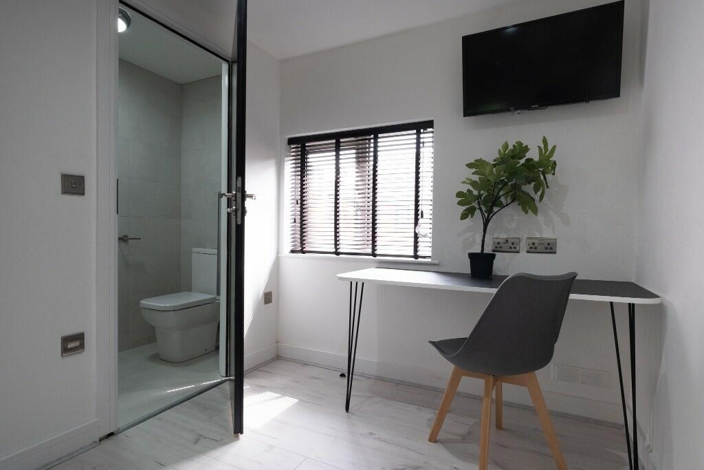 A clean and modern bathroom featuring a shower ...