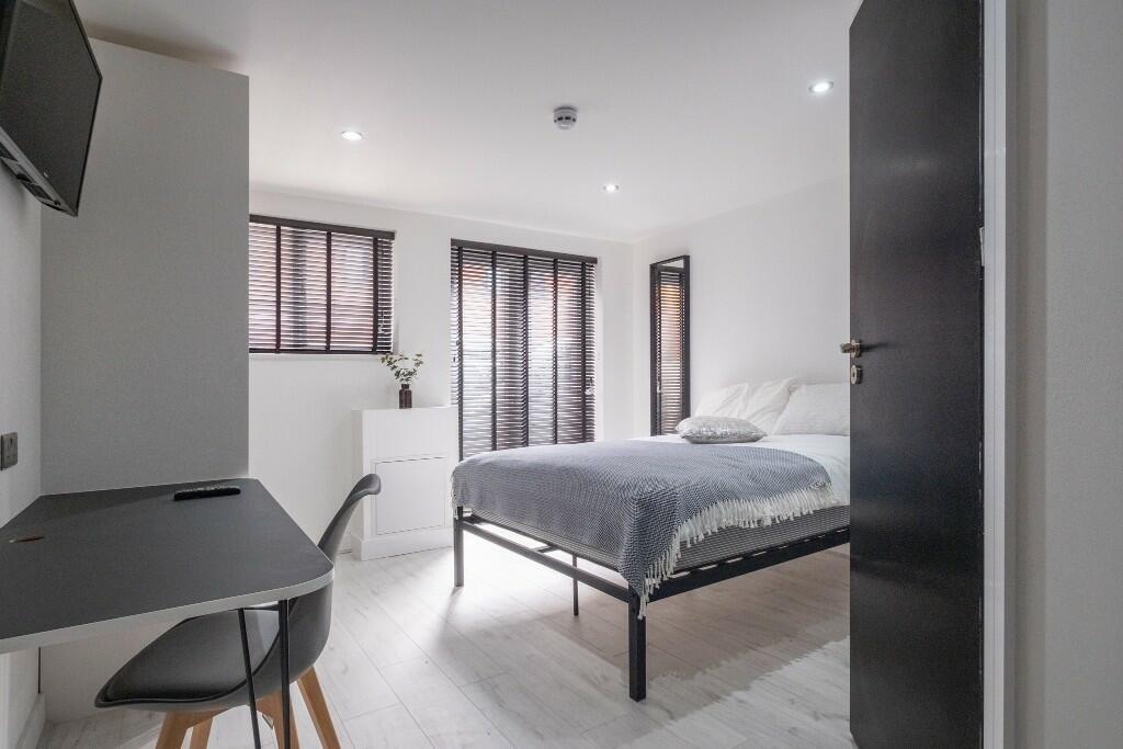 Bright and spacious master bedroom featuring a ...