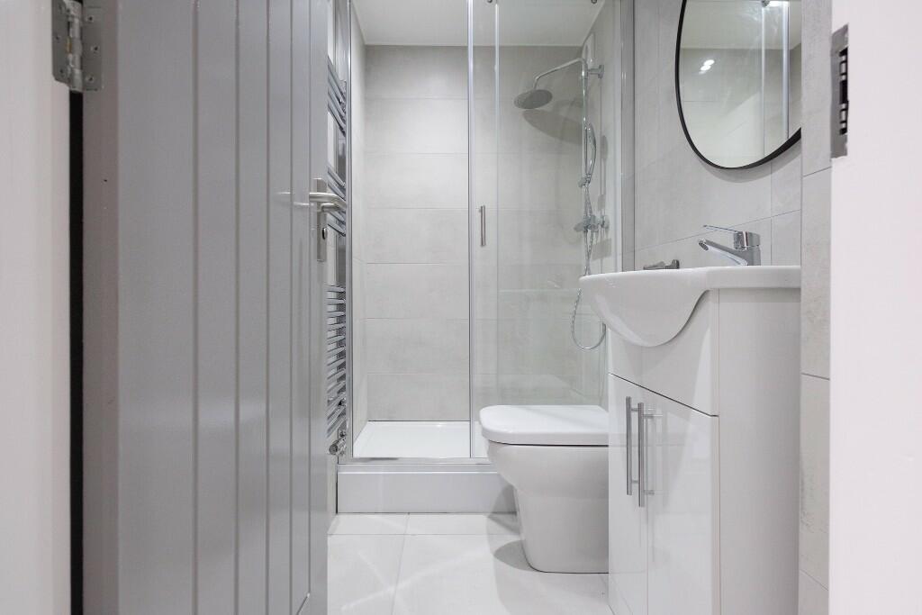 A modern clean bathroom featuring a shower, toi...