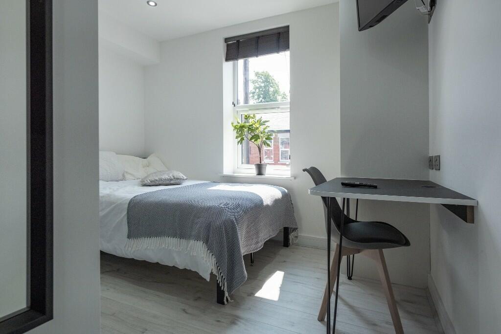 Bright and modern master bedroom with a spaciou...