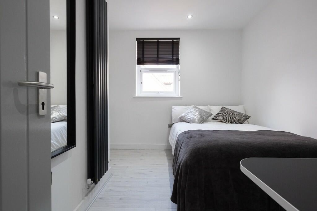 A bright and tidy master bedroom featuring a co...
