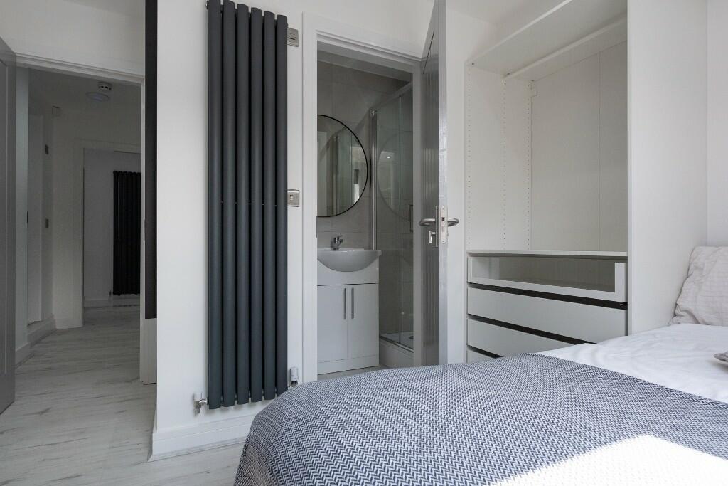 A clean and modern bathroom with a large bath a...