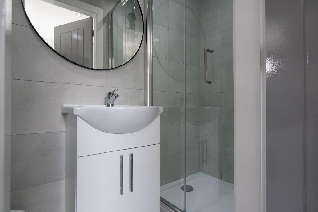 A modern, well-maintained bathroom with a large...