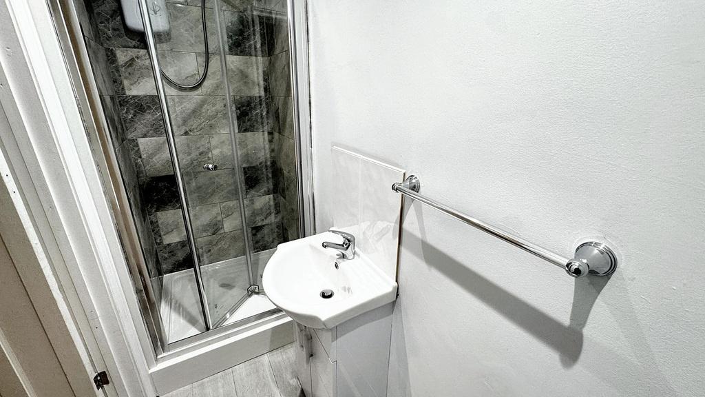 Compact, modern bathroom with a standalone basi...