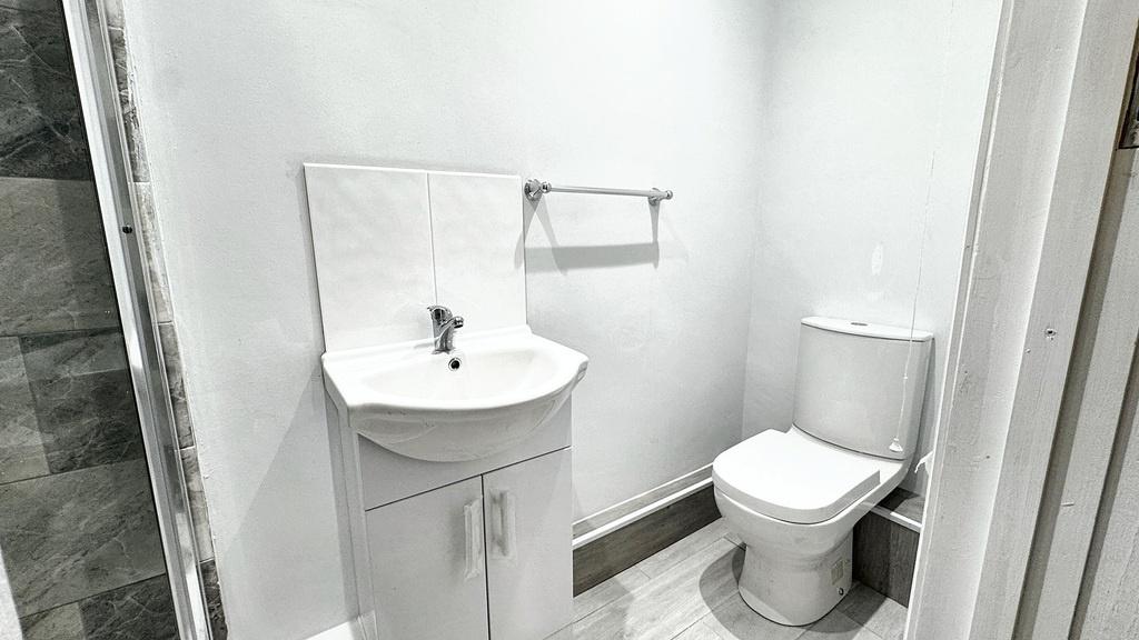 Bright, modern bathroom with a compact vanity u...